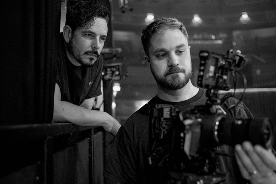 Members of a camera crew filming live music performance